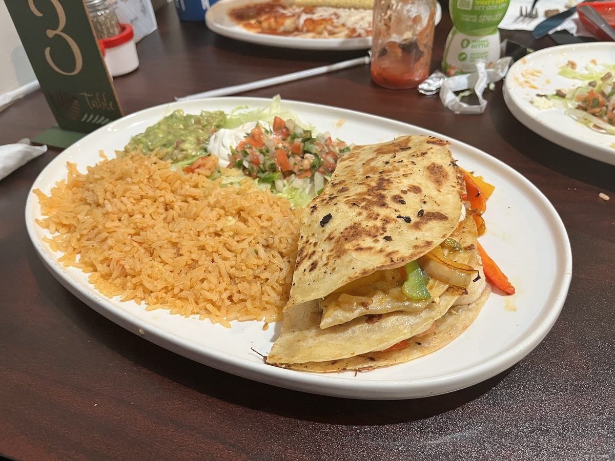 A quesadilla plate with rice and beans